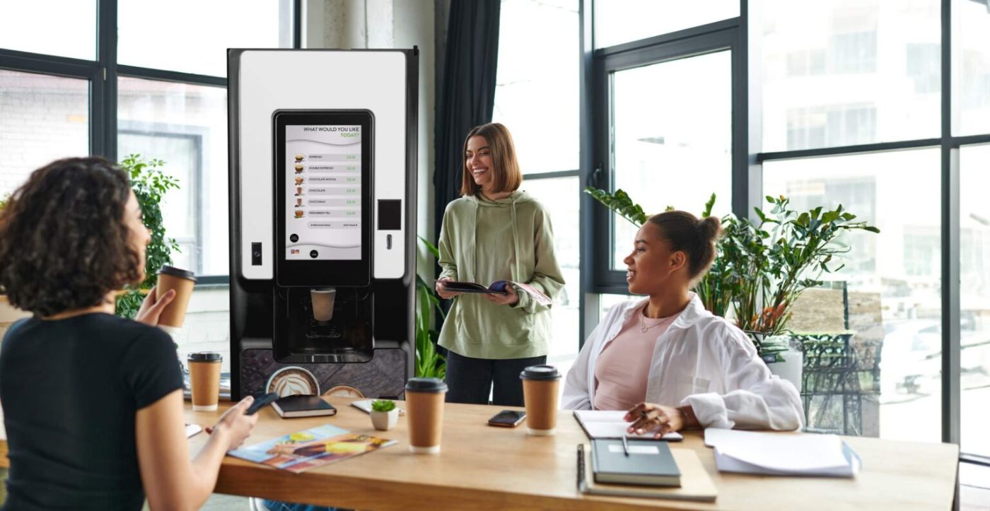 Team enjoying café-quality coffee from a touchscreen coffee machine in a modern Tulsa breakroom
